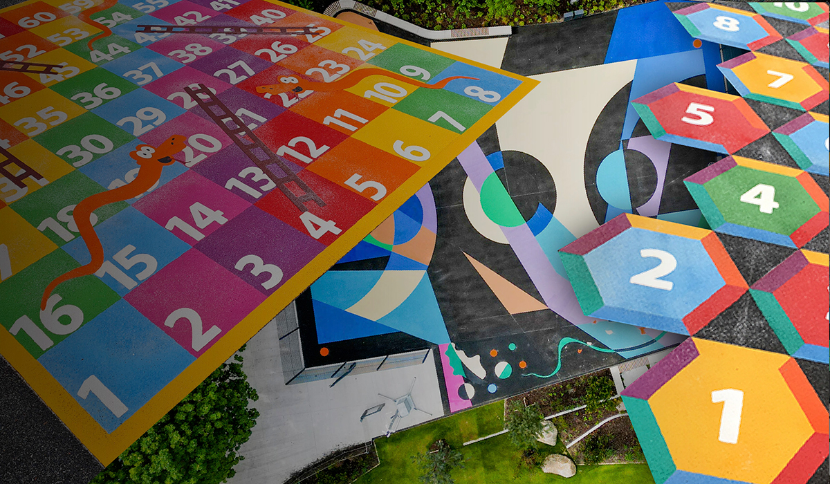 Aerial view of a colourful school playground with a snakes and ladders grid, number hexagons and painted zones