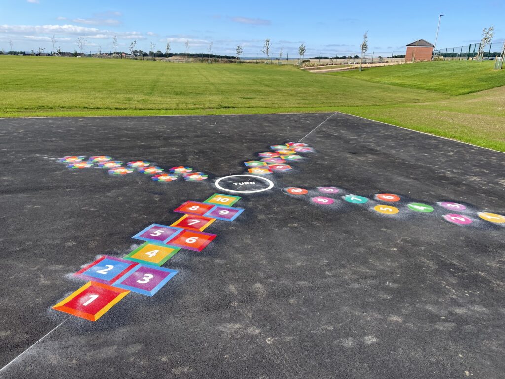 Colourful hopscotch markings on tarmac